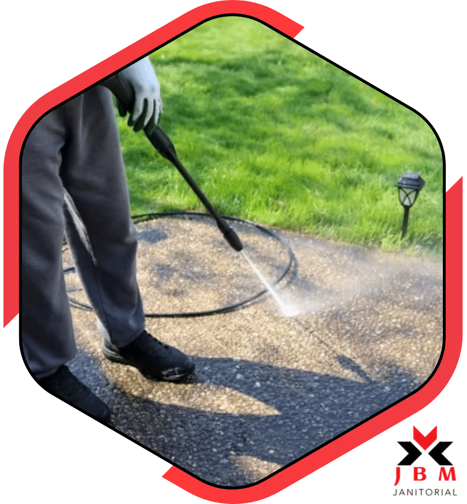 Power washing services professional using a pressure washer to clean a driveway, providing high-quality exterior cleaning solutions for homes and businesses.