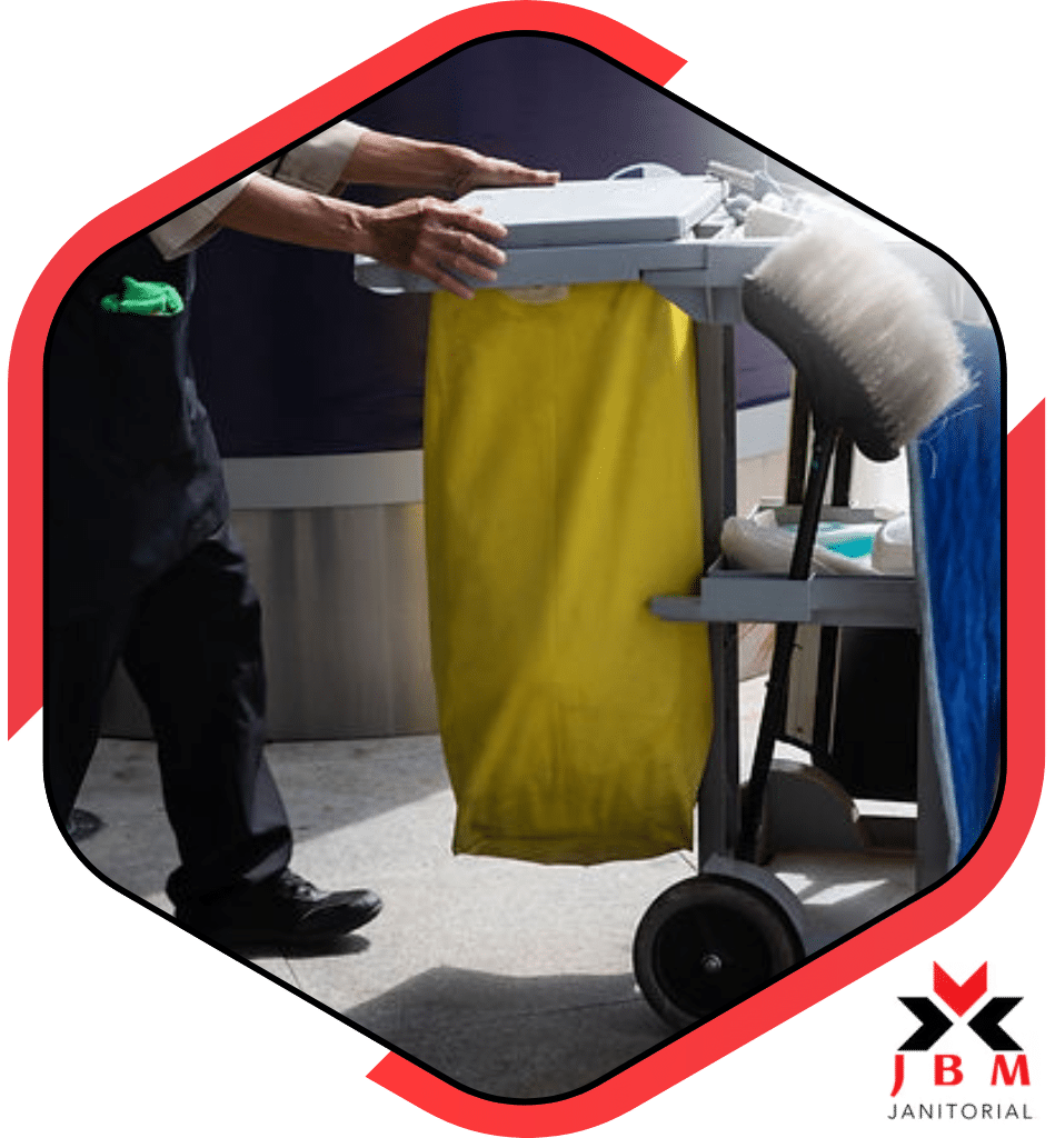 Reliable janitorial cleaning services professional pushing a cleaning cart with tools, offering commercial cleaning solutions for offices and businesses.