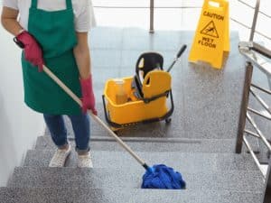 A person cleaning, highlighting the importance of avoiding poor cleaning to maintain a professional business image.