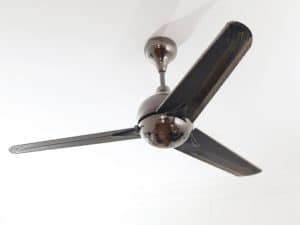 A black ceiling fan with dust on the blades, highlighting the need for cleaning high ceilings.