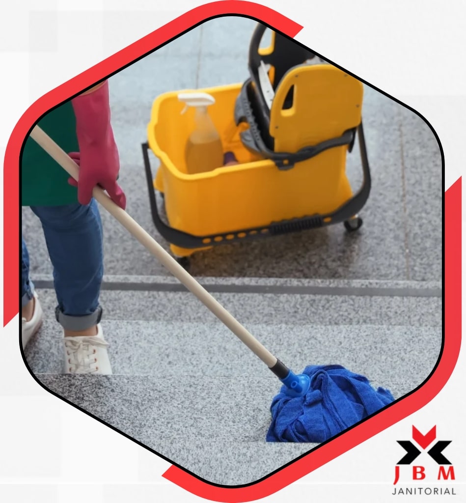 A person diligently mops the floor using a bucket, showcasing professional cleaning services in Streamwood